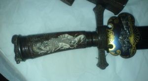 Photo of the decoratively carved handle of a hunting knife