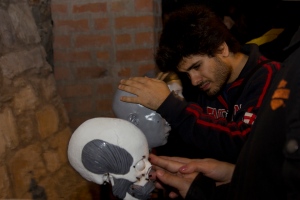 Photo showing a man feeling tactile exhibits of skulls