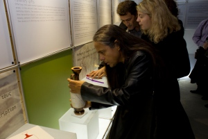 Photo of a man handling a vase exhibit at the exhibition